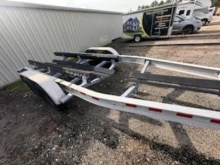 Slide: The Image of Boat trailer for 2005 Grady-White Sailfish 282, parked outdoors on gravel. - 12