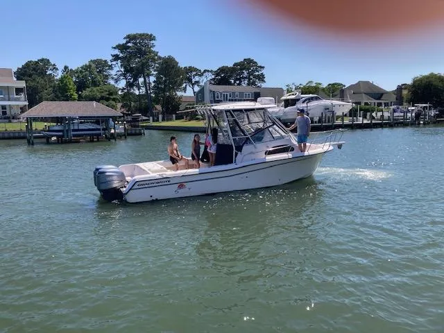 Slide: The Image of 2005 Grady-White Sailfish 282 boat on water with people onboard, near residential docks. - 14