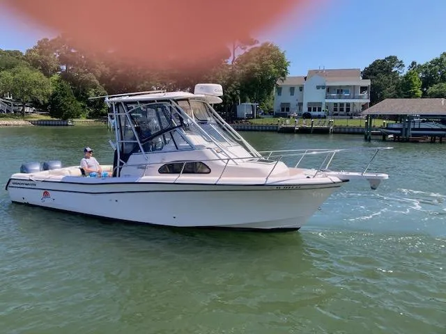 Slide: The Image of 2005 Grady-White Sailfish 282 boat cruising on a sunny day near waterfront homes. - 15