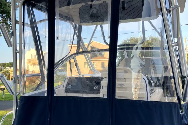 Slide: The Image of 2005 Grady-White Sailfish 282 boat interior with clear enclosure and seating. - 7