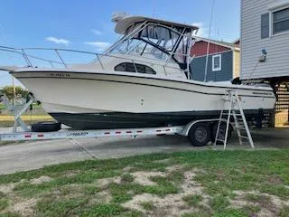 Slide: The Image of 2005 Grady-White Sailfish 282 boat on trailer near house. - 8