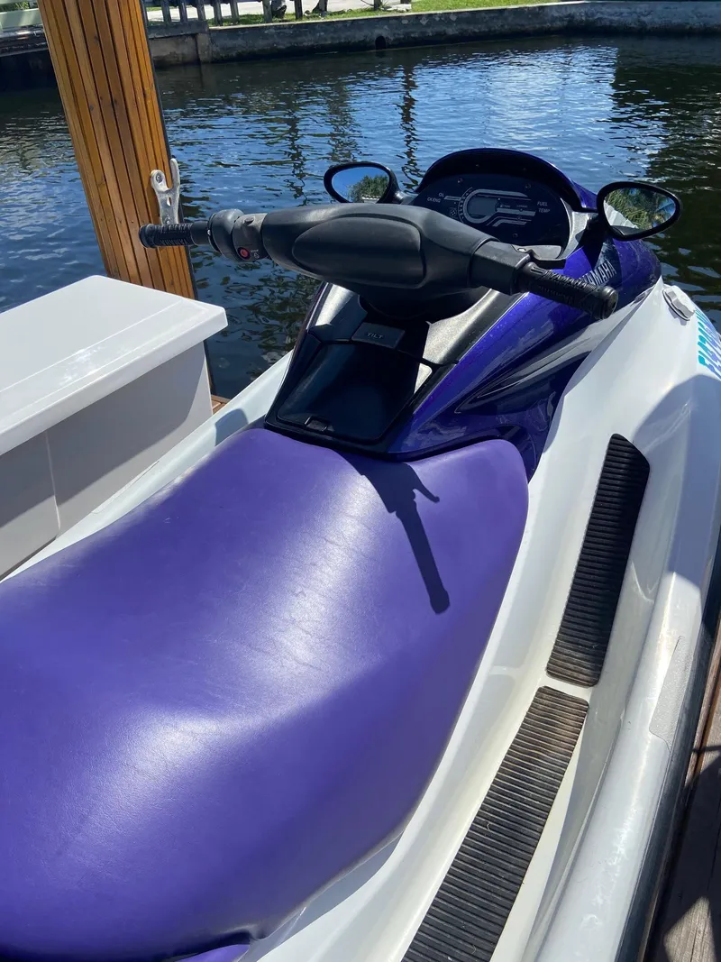 Slide: The Image of 2003 Yamaha WaveRunner FX 140 jet ski docked by the water. - 4