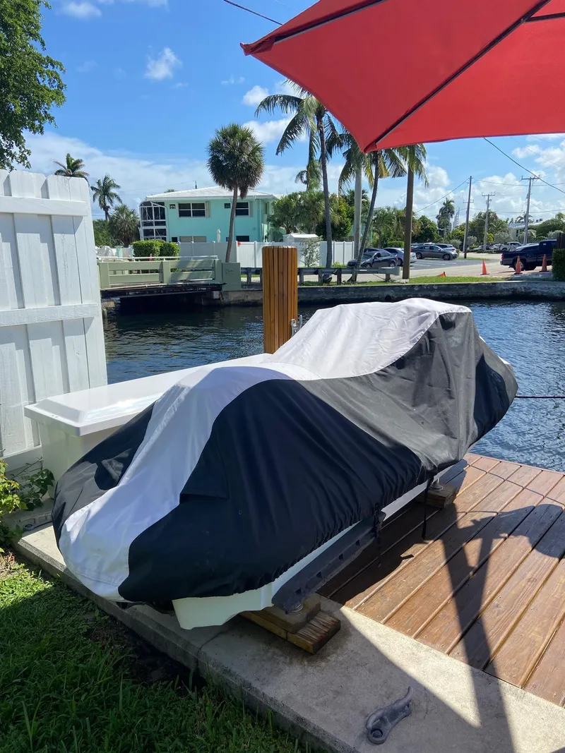 Slide: The Image of 2003 Yamaha WaveRunner FX 140 covered on a dock by a canal. - 7