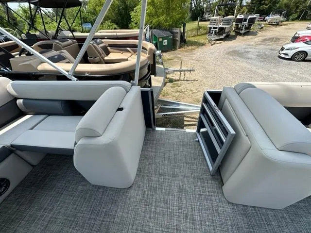 Slide: The Image of 2023 Harris 210 Cruiser pontoon boat interior with gray seating and flooring. - 10