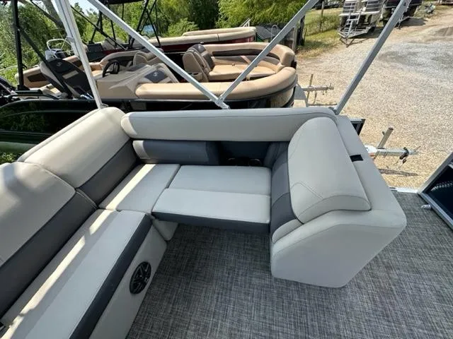 Slide: The Image of 2023 Harris 210 Cruiser boat interior with gray seating and carpeted floor. - 11