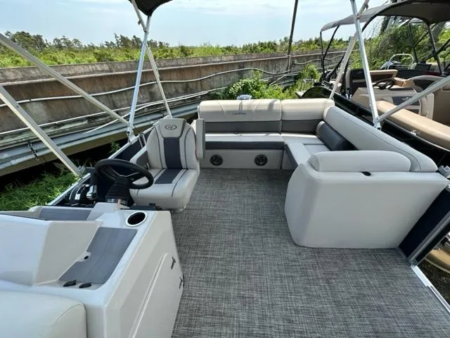 Slide: The Image of 2023 Harris 210 Cruiser pontoon boat interior with spacious seating and modern design. - 9