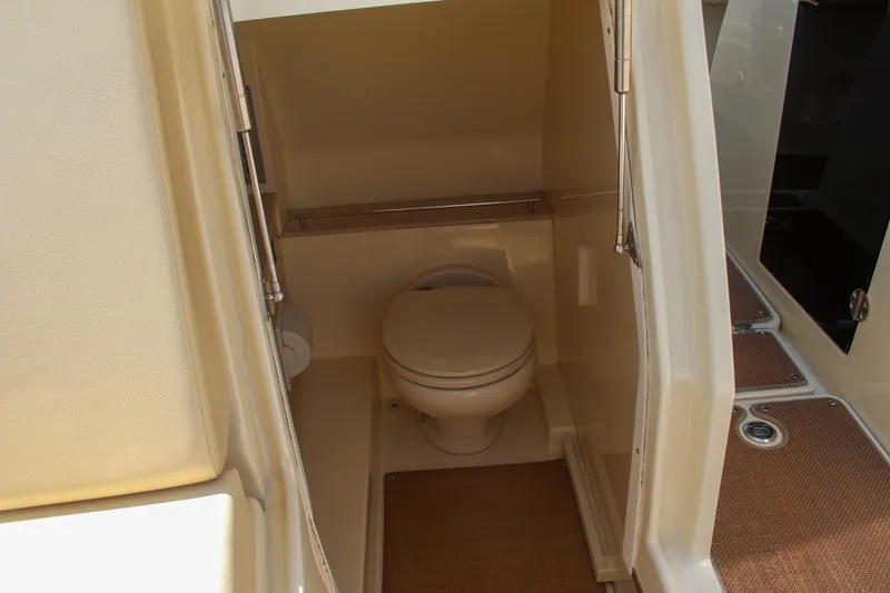 Slide: The Image of 2017 Chris-Craft Calypso 30 boat interior with compact marine toilet. - 10