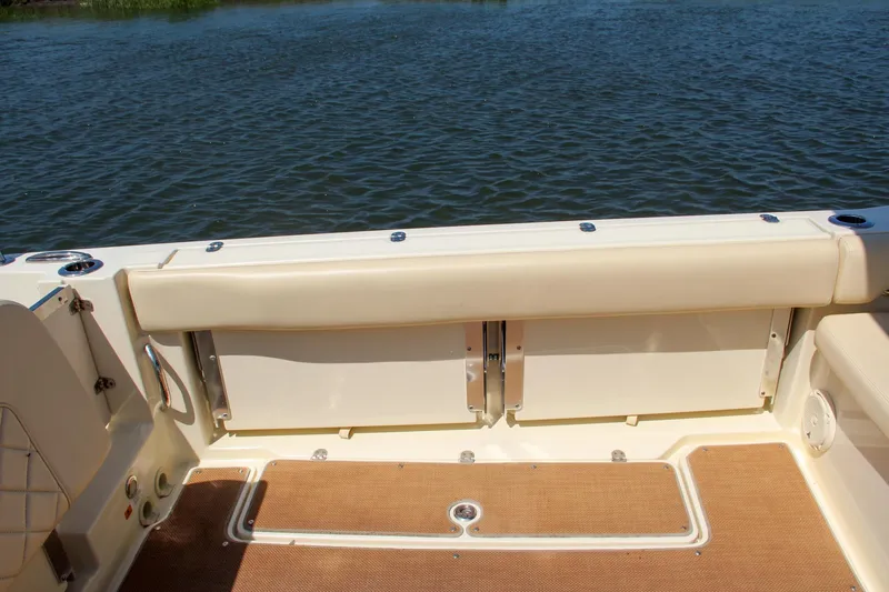 Slide: The Image of 2017 Chris-Craft Calypso 30 boat interior with beige seating and water view. - 14