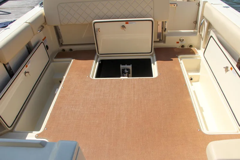 Slide: The Image of 2017 Chris-Craft Calypso 30 boat interior with open storage compartments. - 15