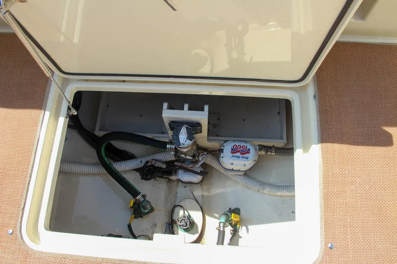 Slide: The Image of 2017 Chris-Craft Calypso 30 boat storage compartment with equipment and wiring. - 17