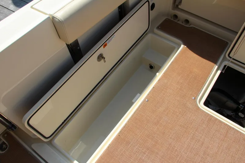 Slide: The Image of 2017 Chris-Craft Calypso 30 boat interior storage compartment with beige carpet. - 18