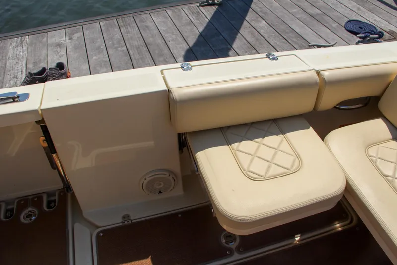 Slide: The Image of 2017 Chris-Craft Calypso 30 boat interior with beige seating and wooden deck. - 20