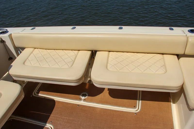 Slide: The Image of Chris-Craft Calypso 30 (2017) boat seating with beige cushions and diamond stitching. - 22