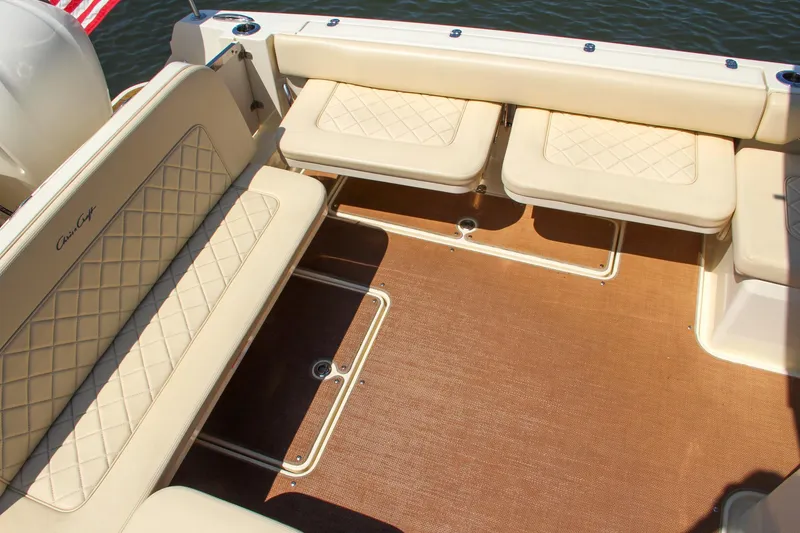 Slide: The Image of 2017 Chris-Craft Calypso 30 boat interior with beige seating and brown flooring. - 24