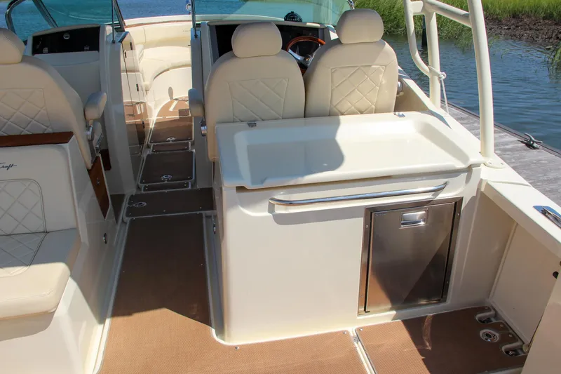 Slide: The Image of 2017 Chris-Craft Calypso 30 boat interior with beige seating and sleek design. - 26