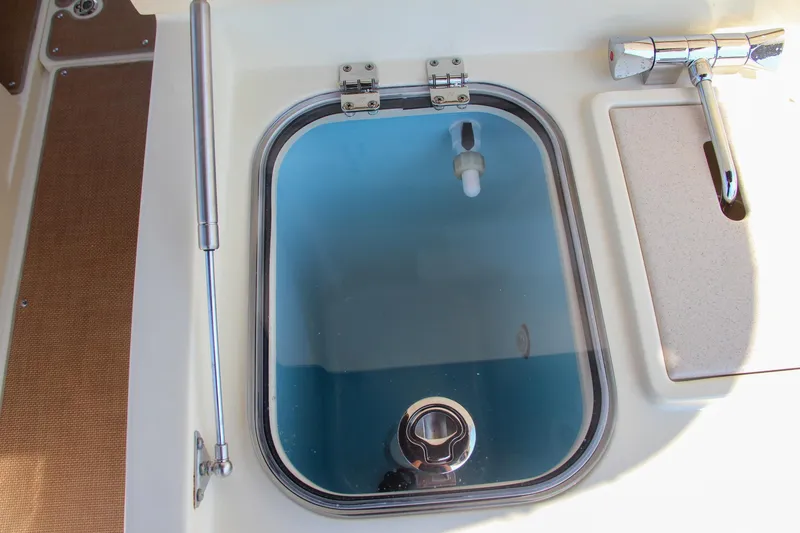 Slide: The Image of 2017 Chris-Craft Calypso 30 boat hatch with handle and latch. - 28
