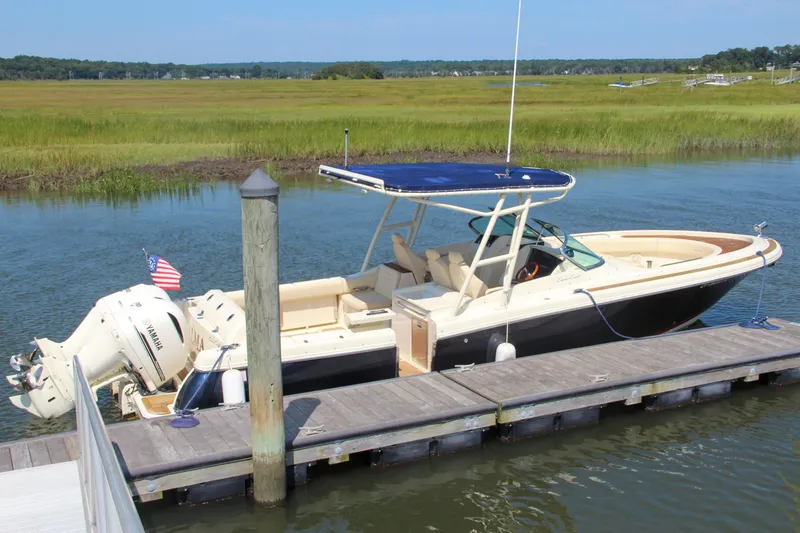 Slide: The Image of 2017 Chris-Craft Calypso 30 boat docked on a serene waterway. - 3