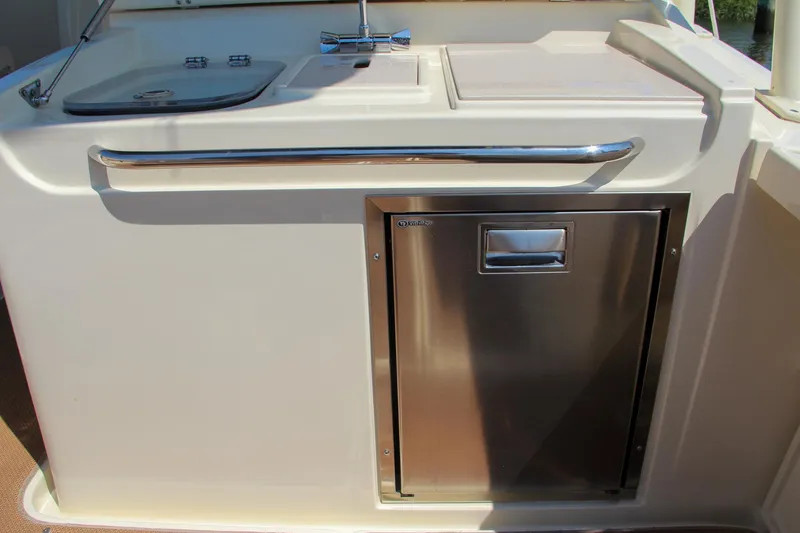 Slide: The Image of 2017 Chris-Craft Calypso 30 boat kitchenette with sink and stainless steel storage. - 30