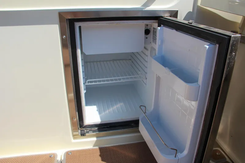 Slide: The Image of Open mini fridge on 2017 Chris-Craft Calypso 30 boat. - 31