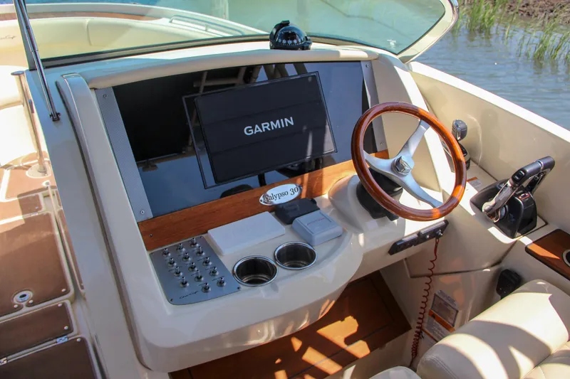 Slide: The Image of 2017 Chris-Craft Calypso 30 helm with Garmin display and wooden steering wheel. - 33