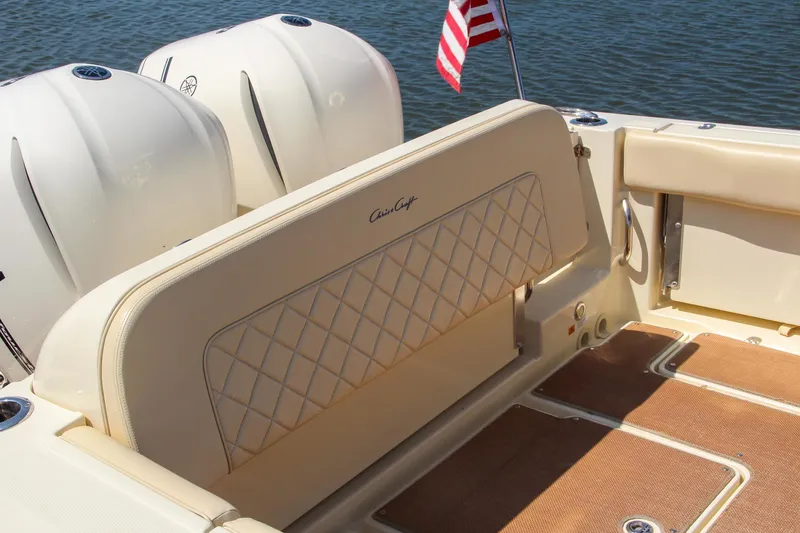 Slide: The Image of 2017 Chris-Craft Calypso 30 boat interior with American flag and twin engines. - 4