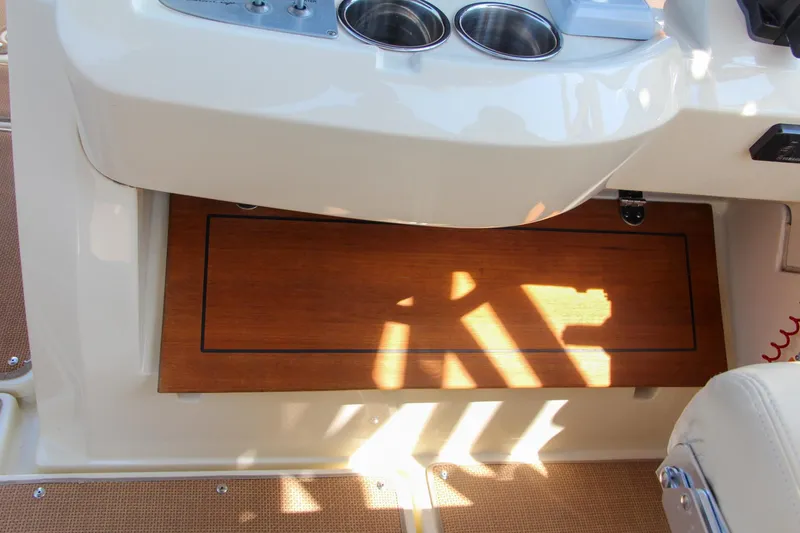 Slide: The Image of Chris-Craft Calypso 30, 2017 model, featuring a sleek cockpit with cup holders and wooden accents. - 41