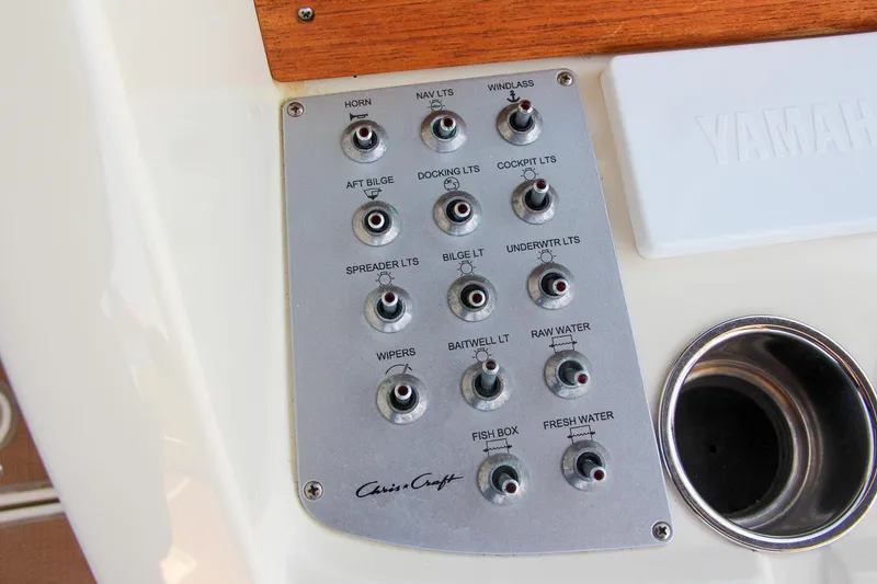Slide: The Image of Control panel of 2017 Chris-Craft Calypso 30 boat with labeled switches. - 42