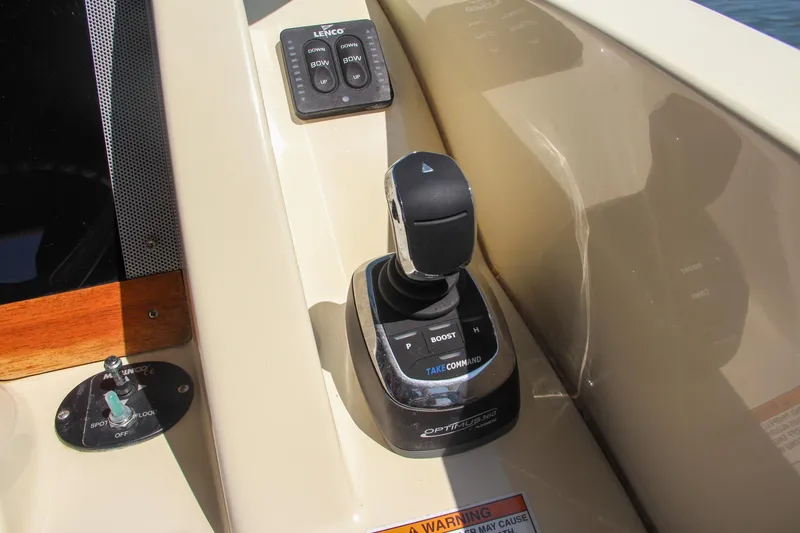 Slide: The Image of 2017 Chris-Craft Calypso 30 boat control panel with joystick and buttons. - 44