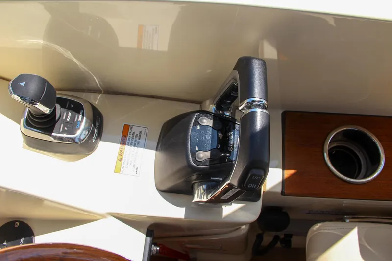 Slide: The Image of 2017 Chris-Craft Calypso 30 boat controls and throttle detail. - 45