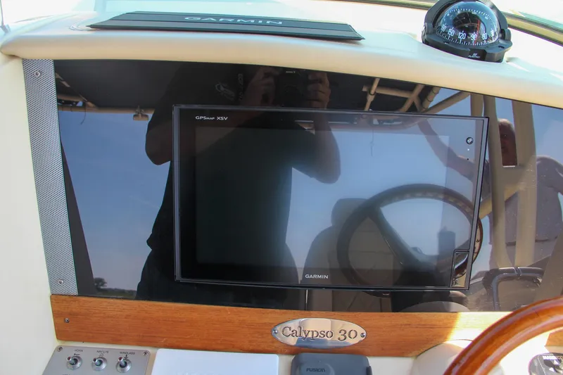 Slide: The Image of 2017 Chris-Craft Calypso 30 dashboard with Garmin display and compass. - 47