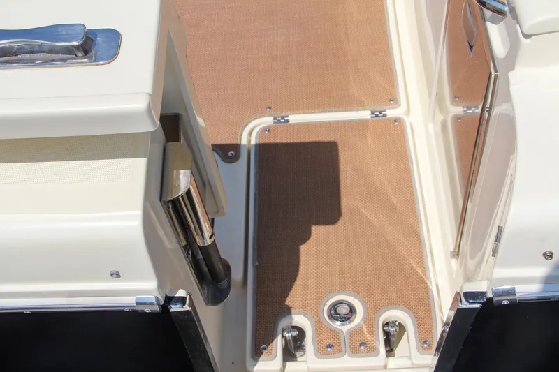 Slide: The Image of 2017 Chris-Craft Calypso 30 boat deck with tan flooring and stainless steel fixtures. - 5