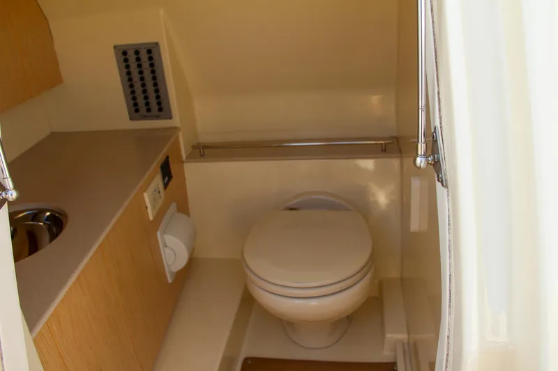 Slide: The Image of 2017 Chris-Craft Calypso 30 boat bathroom interior with toilet and sink. - 7