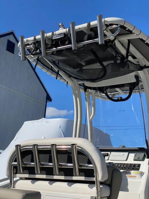 Slide: The Image of 2021 Finseeker 206 CC boat with rod holders and console, docked near a building. - 8