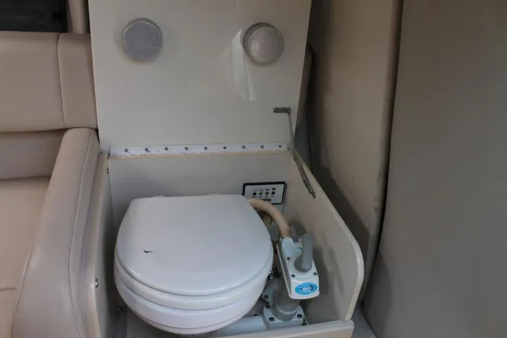 Slide: The Image of 2001 Formula 260 Sun Sport boat interior with compact marine toilet. - 15