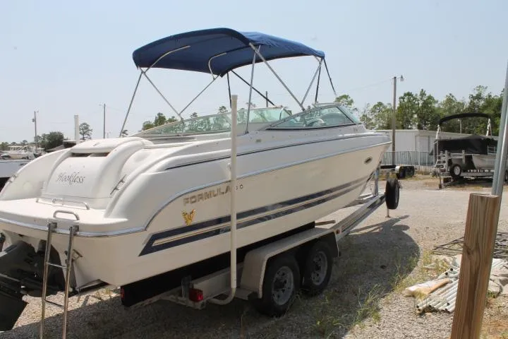 Slide: The Image of 2001 Formula 260 Sun Sport boat on trailer with blue canopy in outdoor setting. - 5