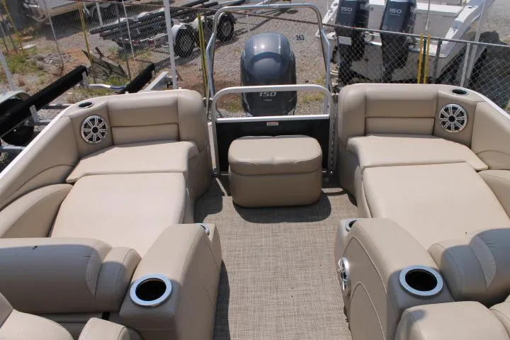 Slide: The Image of 2015 Bennington 2275 GCW pontoon boat interior with beige seating and cup holders. - 10