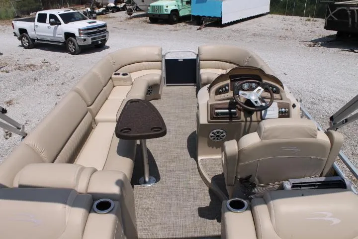 Slide: The Image of 2015 Bennington 2275 GCW pontoon boat interior with beige seating and steering console. - 11