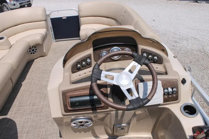 Slide: The Image of 2015 Bennington 2275 GCW boat interior with steering wheel and control panel. - 12
