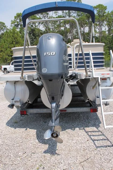 Slide: The Image of 2015 Bennington 2275 GCW pontoon boat with Yamaha 150 outboard motor, parked on gravel. - 4
