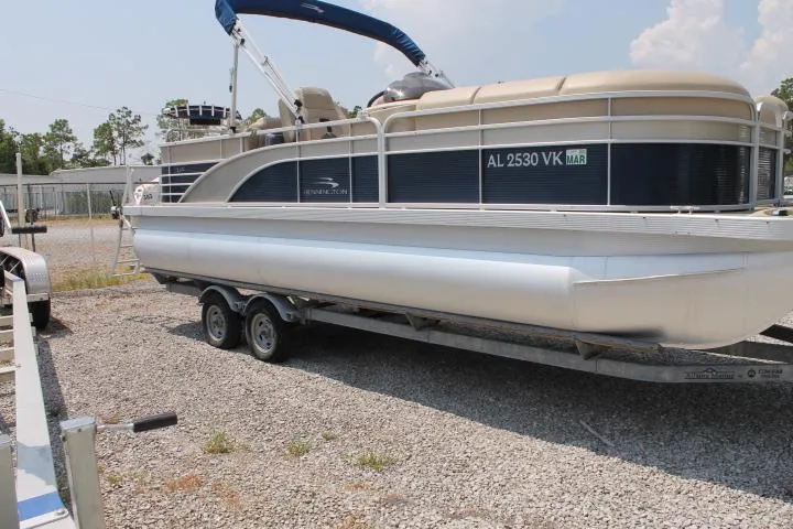 Slide: The Image of 2015 Bennington 2275 GCW pontoon boat on trailer, parked on gravel lot. - 8