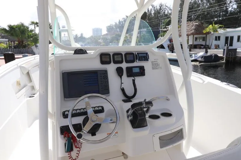 Slide: The Image of 2013 Sailfish 320 CC boat console with navigation and control systems. - 2