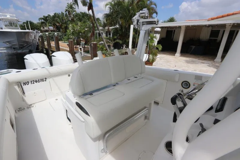 Slide: The Image of 2013 Sailfish 320 CC boat interior with seating and controls. - 5