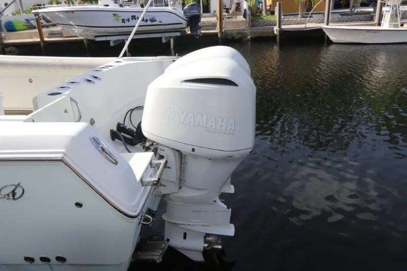 Slide: The Image of 2013 Sailfish 320 CC boat with Yamaha outboard motor docked. - 7
