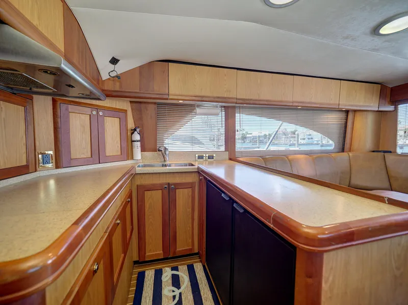 Slide: The Image of 2005 Luhrs 41 Convertible yacht kitchen with wood cabinetry and ample counter space. - 17