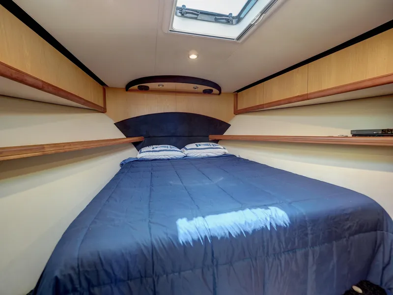 Slide: The Image of 2005 Luhrs 41 Convertible cabin with bed and skylight. - 18