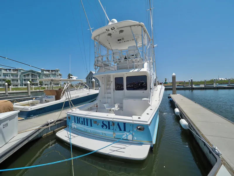 Slide: The Image of 2005 Luhrs 41 Convertible yacht docked at marina on a sunny day. - 2