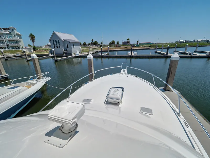 Slide: The Image of 2005 Luhrs 41 Convertible yacht docked at a marina on a sunny day. - 27