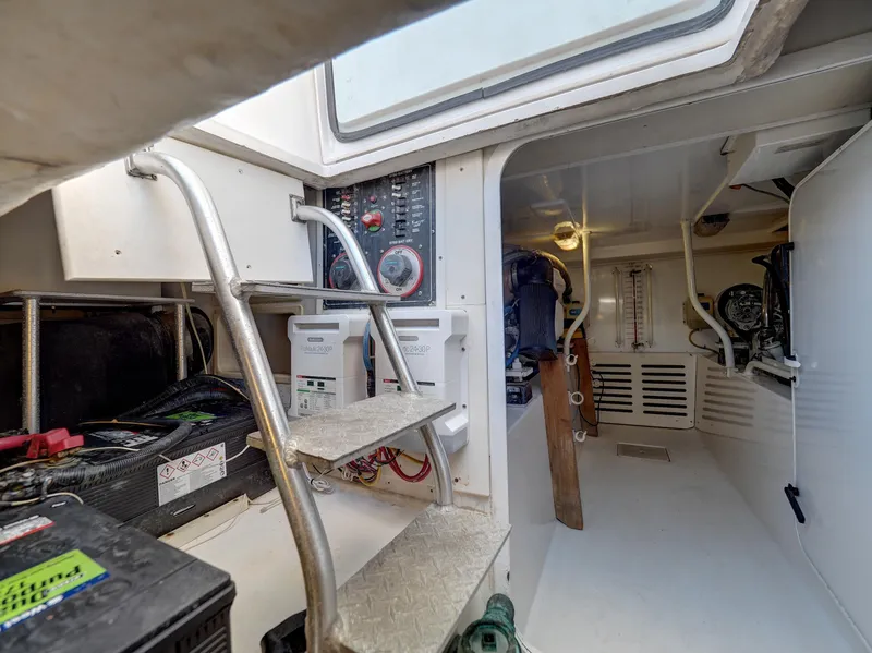 Slide: The Image of 2005 Luhrs 41 Convertible engine room with control panels and equipment. - 31