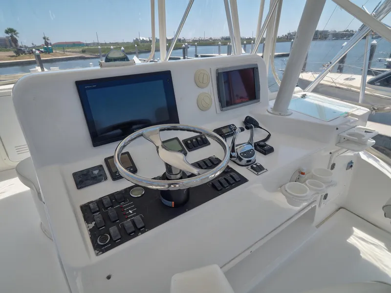 Slide: The Image of 2005 Luhrs 41 Convertible helm station with navigation screens and controls. - 41