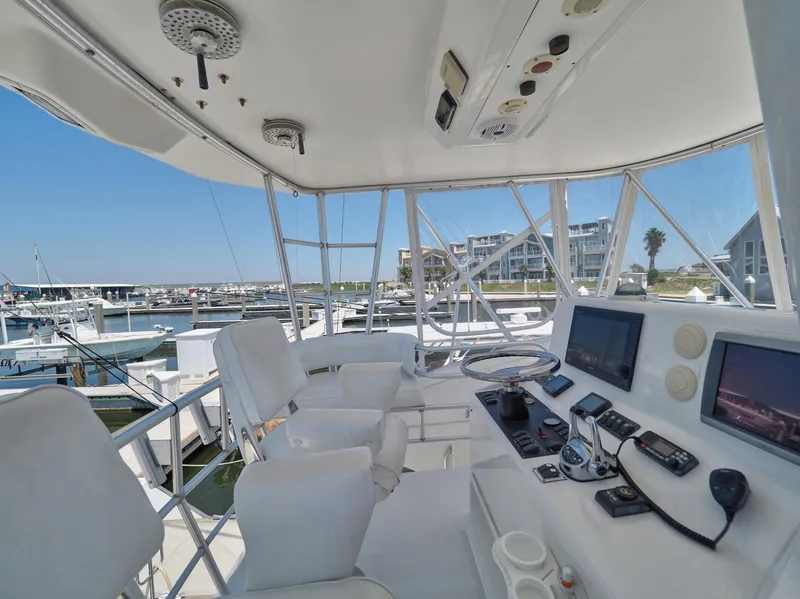 Slide: The Image of 2005 Luhrs 41 Convertible yacht helm station with marina view. - 42